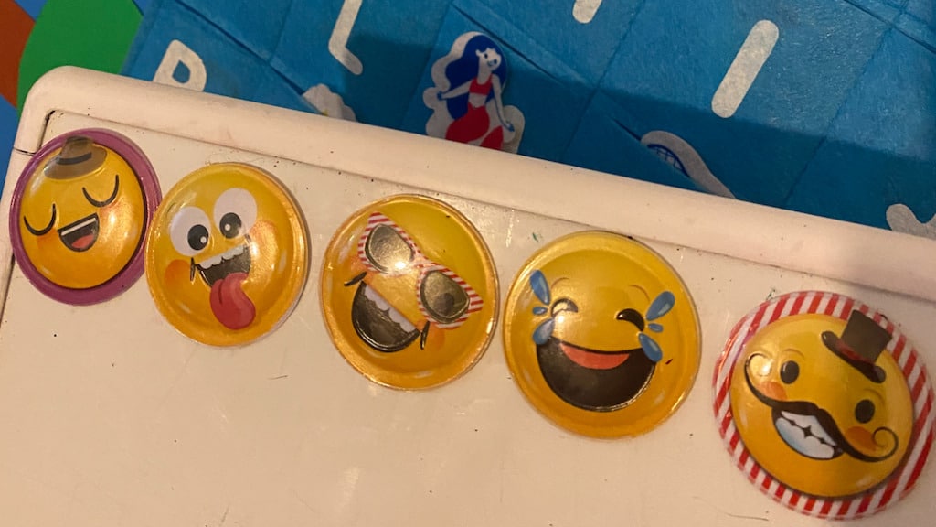 a photo of 4 emoji faces made into magnets and placed on my whiteboard to use as a reward system while teaching