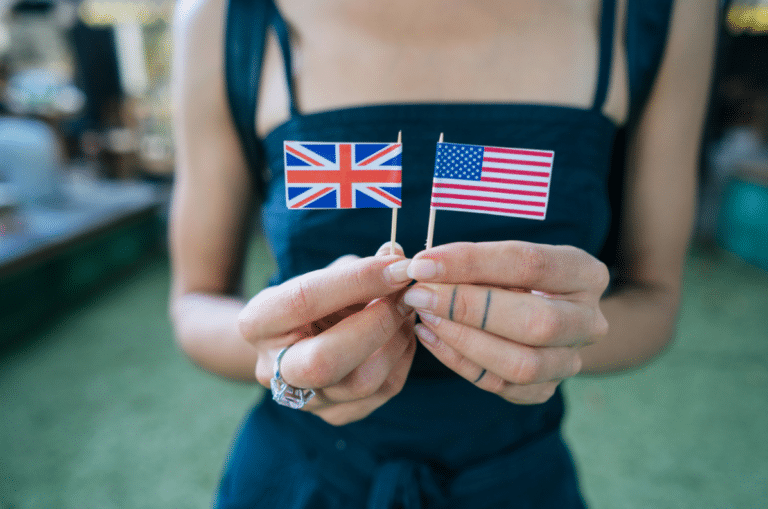 a woman holding a flag of America and the UK in her hands