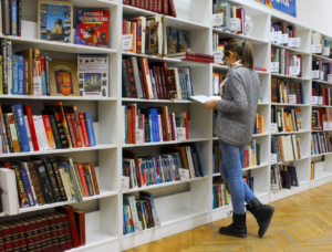 a photo of a woman perusing books at a bookstore