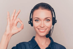 a woman giving the A ok sign while wearing headphones
