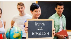 students holding a blackboard that says French to English with arrows